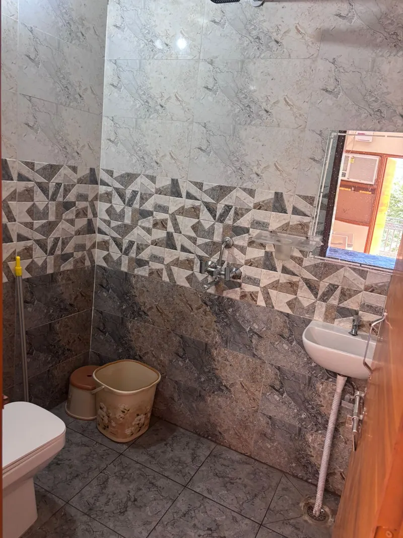 Attached bathroom with shower and wash basin at Yadav PG Gurugram