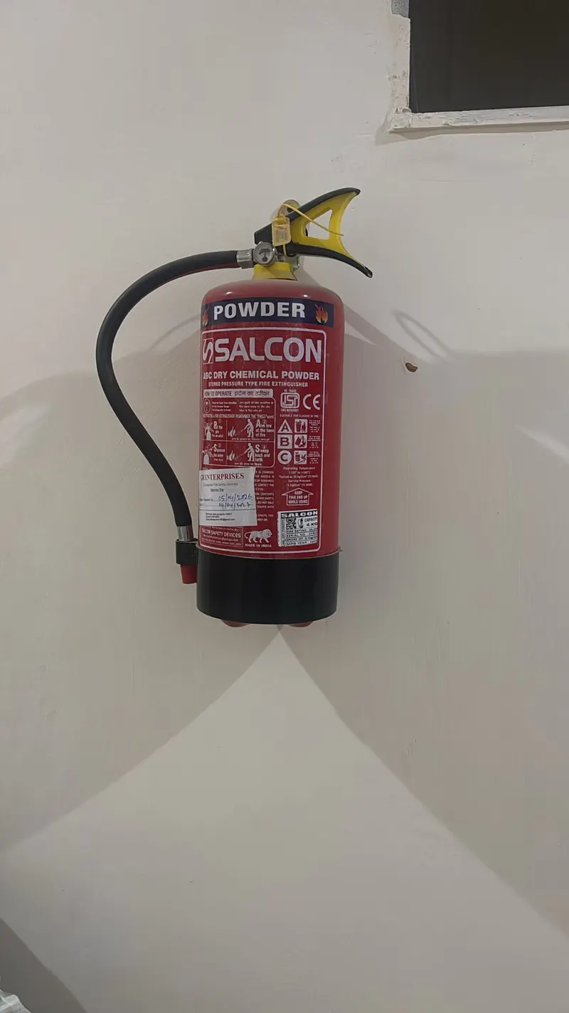 Fire extinguisher installed for fire safety at Yadav PG Gurugram