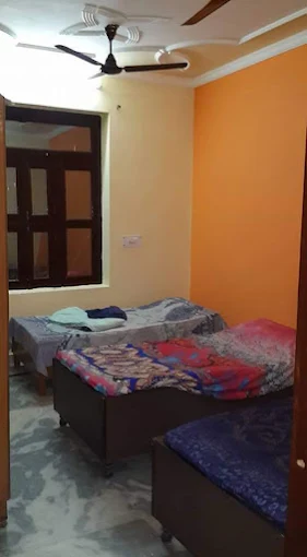 Another view of a furnished room at Yadav PG in Dwarka
