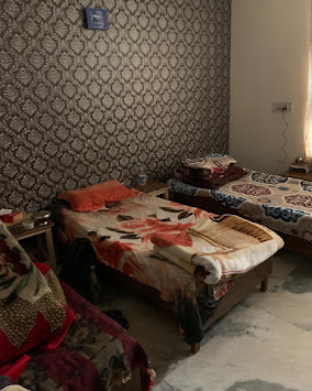 Triple-sharing room at Yadav PG in Dwarka