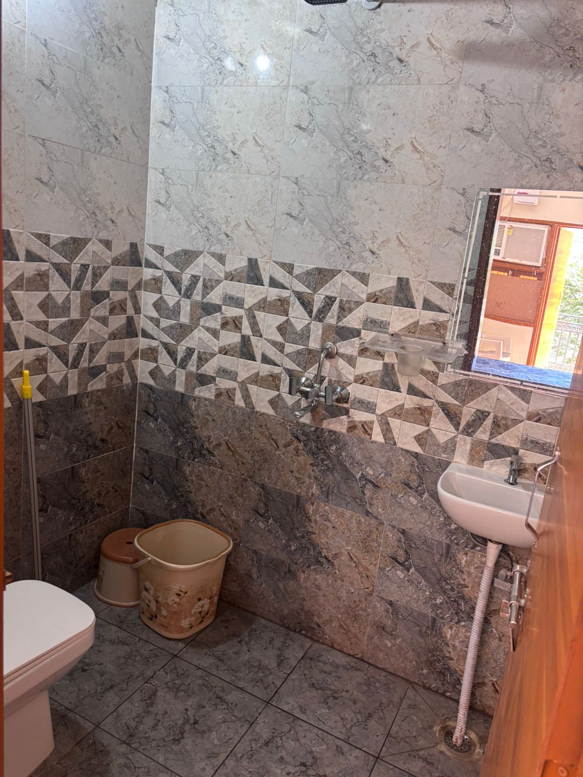 Attached bathroom with shower and wash basin at Yadav PG Gurugram